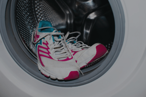 Shoes being washing in a washing machine to prevent athlete