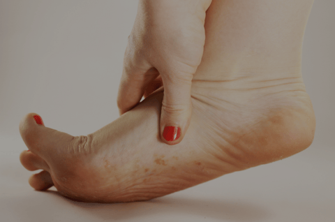 Woman with itchy foot wondering if she has foot eczema or athlete