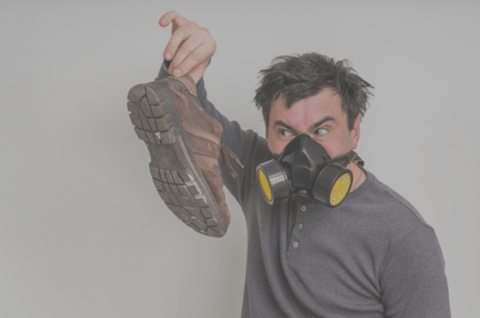 Man holding shoes with strong athlete