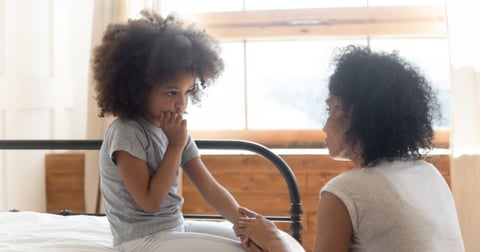 Worried mom hugging her daughter outdoors while thinking about ringworm infection